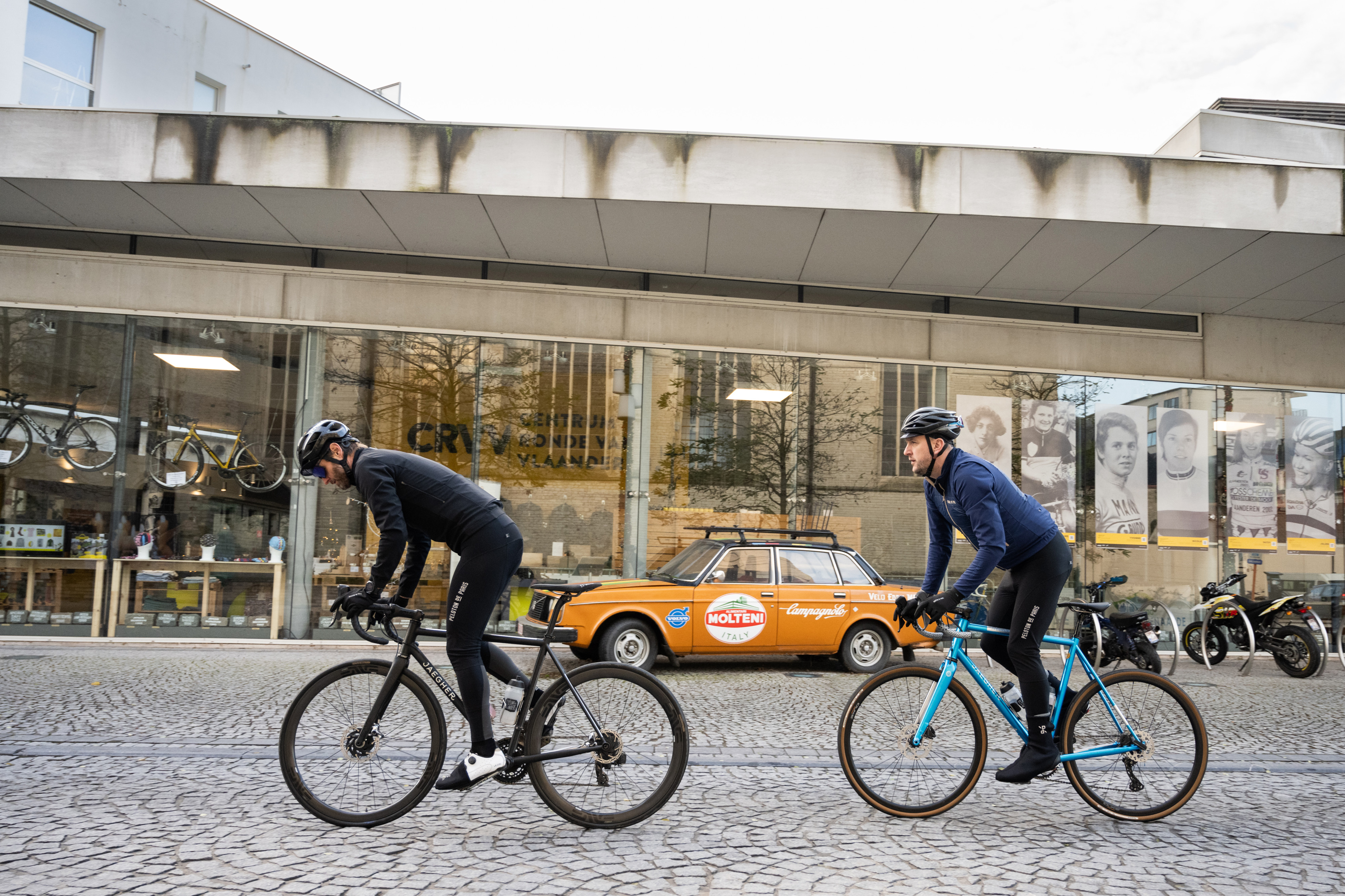 Cyclists passing by the Centrum Ronde van Vlaanderen